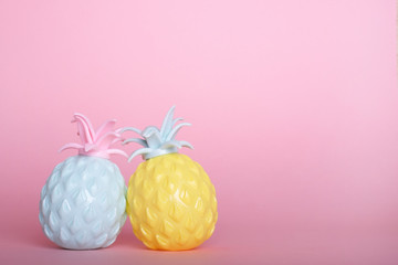 Two pineapples on a pink background and space for your advertising or promotional text.