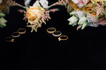 wedding rings with a bouquet and boutonniere