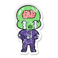 distressed sticker of a cartoon big brain alien crying