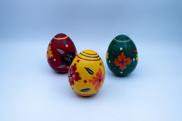 Colorful wooden easter eggs and chocolate with a touch of spring