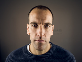 Obraz premium Portrait of a young man looking at the camera with serious expression