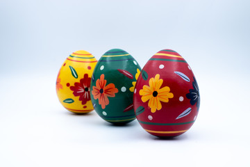 Colorful wooden easter eggs and chocolate with a touch of spring