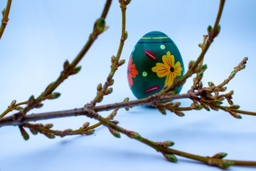 Colorful wooden easter eggs and chocolate with a touch of spring