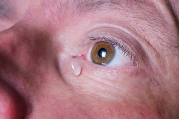 Fototapeta premium Eye of sad man with tear