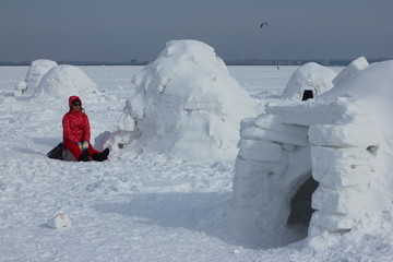 Young woman relax in snow Igloo. Winter vacation. Winter and new year holidays concept. 