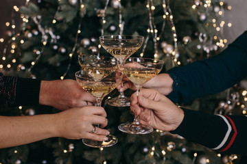 glasses with champagne on the background of light bulbs