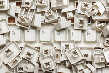 The word repair from a pile of computer keys