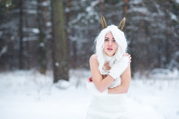 Cosplay girl in fantasy style in snow in winter
