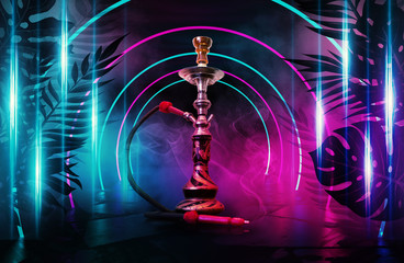 Hookah on the background of tropical leaves and a brick wall. Neon light, laser figures in smoke