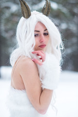 Cosplay girl in fantasy style in snow in winter