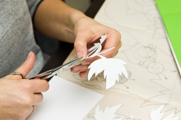 Woman doing paper cutouts