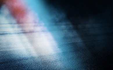 Dark empty stage, blue and orange neon spotlight, wet asphalt, smoke, night shooting, rays