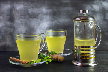 Two mugs and a french press with sea buckthorn tea
