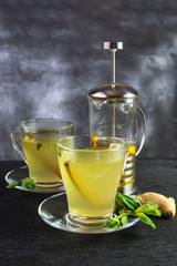 Two mugs and a french press with sea buckthorn tea