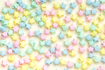 Fototapeta na wymiar Beautiful background with light multi-colored paper stars