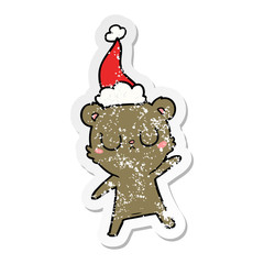 peaceful distressed sticker cartoon of a bear wearing santa hat