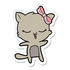 sticker of a cartoon cat with bow on head