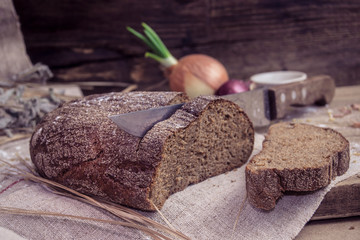 Freshly baked rye bread on rustic background
