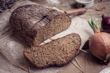 Freshly baked rye bread on rustic background