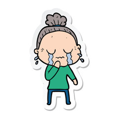sticker of a cartoon old woman crying