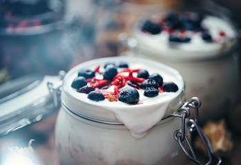 Natural yogurt, organic greek bio yoghurt homemade with fresh fruits, goji and berries, ready for diet breakfast, sweet tasty dessert in a jar for the morning