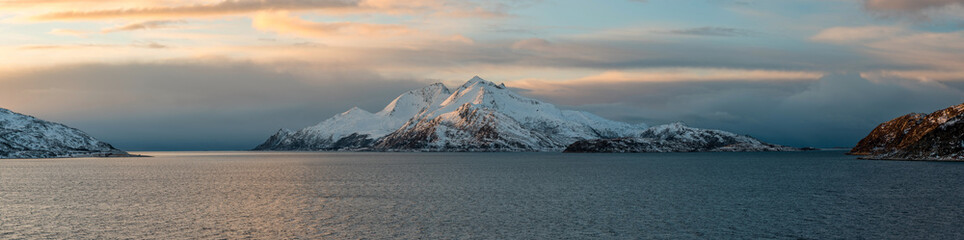 Panoramic view of the snowy island Vengsoya close to arctic town Tromso during sunset, Norway © Zdenar Adamsen