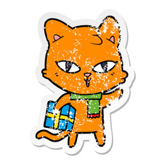 distressed sticker of a cartoon cat with a present