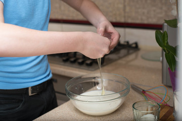 teenage boy cooking at home.
