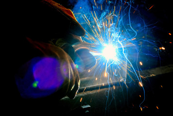 Fototapeta na wymiar moment of contact of the electrode to the metal electric welding with sparks