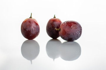 Three red grapes isolated