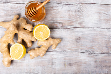 Copy free space. Healthy concept. Tea, lemon, ginger, honey on a white background. Flat lay. Treatment of cold and viruses. Be healthy