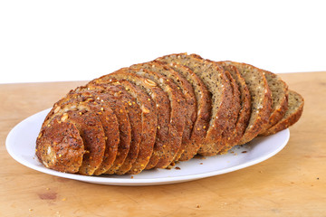 Sliced Loaf of Homemade Pumpkin Seed Bread on White BG with copy space