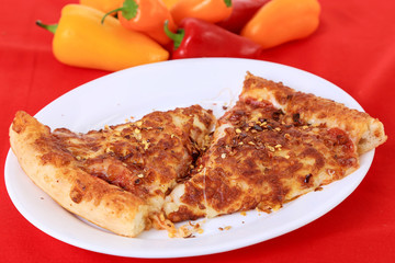 Spicy Red Pepper on Pizza Snack on Red BG and Surrounded by Hot Peppers