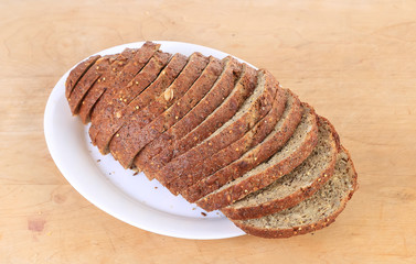 Loaf of Homemade Pumpkin Seed Bread on Wooden Cutting Board