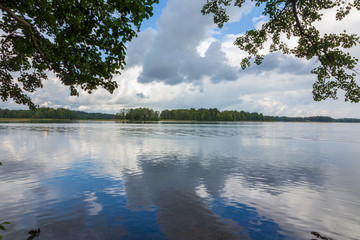 Peaceful lake in summer under stormy sky