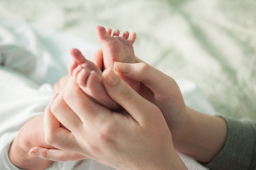 baby feet in mother's hands