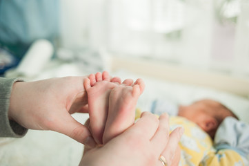 baby feet in mother's hands