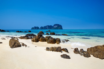Beautiful tropical beach with clear blue water. Coral island Thailand