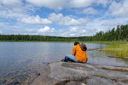 man sitting at lake