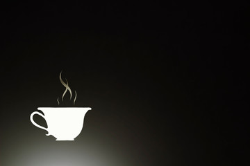 freshly brewed aromatic coffee in a white cup isolated on a dark background