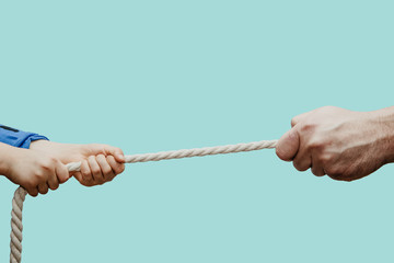 Dragging a child's rope with an adult. Conflict of children with adults. Concept of problems of children and adults. Misunderstanding of children and their needs, imposing the will of adult children.