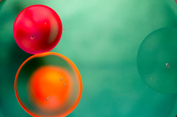 orange and red bubbles on green background