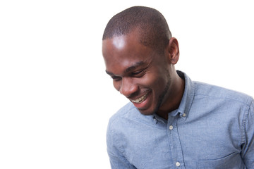 Close up happy young businessman laughing against isolated white background