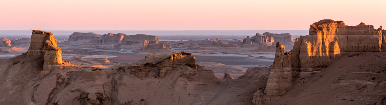 Panoramic view of sandy mountains in Kaluts desert, part of Dasht-e Lut desert during sunrise, Iran © Zdenar Adamsen