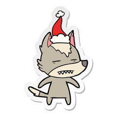 sticker cartoon of a wolf showing teeth wearing santa hat