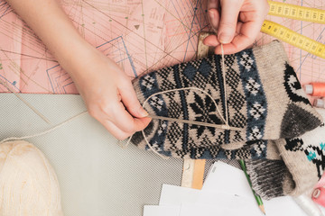 seamstress hold finished wool socks in the studio