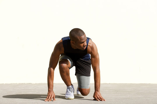 african american man in starting position for race