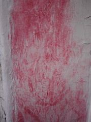 Lipstick smeared on weathered white painted wood