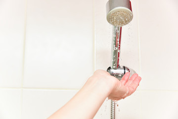 Taking a shower. Water drops in the shower.