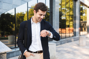 Confident young business man carrying bag